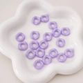 Pastel purple wavy acrylic spacer beads for handmade DIY jewelry on a white tray - Purple