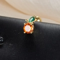 Macro detail of fruit stud earring with orange crystal and green leaf on black silk - Orange Style (60075-4 Gold)