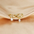 Detail of gold drop earrings with teardrop zircon on elegant champagne silk fabric - White Pendant (E1045-Gold White)