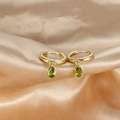 Detail view of golden hoop earrings featuring olive green drop-shaped zircon on silk fabric - Light Green Pendant (E1045-Gold Light Green)