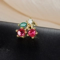 Macro shot of cherry stud earring with red gemstones and green leaf on silk background - Red and White Rhinestone Cherry Style (60075-12 Gold Tone)