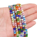 Vibrant multi-colored cat eye beads for DIY jewelry making held in hand for size - 5mm (Hole Approx 0.8mm) 40 Pieces/Pack / Multi-color