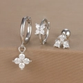 Detailed close-up of three silver earrings with clover zircon charms and crystal studs - Silver (Y26002-7)