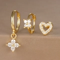 Detailed macro shot of 925 silver gold-plated earring set with zircon flower and heart charms - Hollow Heart Style (Y26003-11) / Gold