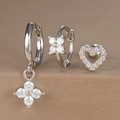Detailed close-up of a silver earring set with floral pendants and heart studs - Hollow Heart Style (Y26003-11) / Silver