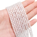 Polished white cat eye round beads for DIY jewelry making shown held in hand - 4mm (Hole Approx 0.6mm) Approx 95 Pieces/Pack / White