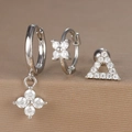 Detail of silver clover earrings set with clear zircon stones on textured background - Hollow Triangle Flower Style (Y26003-17) / Silver