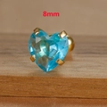 Close-up of 8mm light blue heart zircon stud with gold screw back on wood surface - 8mm / Gold