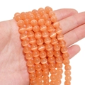 Orange cat-eye round beads for DIY jewelry making held in hand on white background - 8mm (Hole Approx 1.2mm) Approx 50 Pieces/Pack / Orange