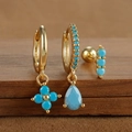 Detail of S925 sterling silver turquoise drop earrings and stud set on wooden stand - Gold Style 5