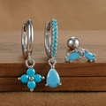 Macro view of S925 sterling silver earrings set with turquoise floral and drop charms - Silver Style 6