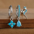 Macro view of S925 silver earring set featuring turquoise floral and snake charms - Silver Style 7