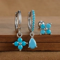 Detailed close-up of S925 silver turquoise clover earrings set on a wooden surface - Silver Style 9