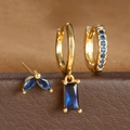 Detalle de set de pendientes dorados con circonitas azul zafiro y formas geométricas - Juego Circonia Azul Oro