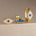 Primer plano del set de pendientes de ojo de la suerte dorados con detalles azules - Juego de 3 Piezas Ojo Turco Corona (Y26036-6)