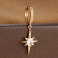 Macro detail of gold north star earrings with crystals on brown leather jewelry box - E1652 (E1652) / 1 Piece/Pack / Gold-White