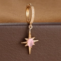 Macro shot of gold octagonal star earring with a pink gem and sparkling crystals - E1652 (E1652) / 1 Piece/Pack / Gold-Pink