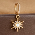 Macro view of gold star earrings with white stone and zircon details on jewelry box - Octagram White Center Stone Style (E1653-2) / Gold