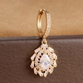 Detail of gold starburst hoop earring featuring pear-cut and baguette-cut zircons - Pear Cut Radiant Flower Style (E1653-4) / Gold