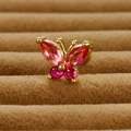 Elegant gold butterfly stud earrings with pink crystal gemstones on brown velvet background - Gold Rose Red Rhinestone