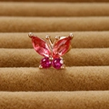 Macro view of gold butterfly ear stud with red and pink crystals on velvet - Rose Gold Rose Red Rhinestone
