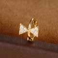 Macro shot of a golden bow huggie earring with sparkling white cubic zirconia stones - Bowknot Style (Y20487-4) / 1 Piece / Gold