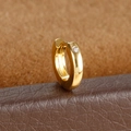 Macro shot of gold huggie hoop earring with a round-cut clear zircon on leather texture - Solitaire Style (Y20487-11) / 1 Piece / Gold