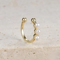 Macro detail of elegant gold-plated ear cuff with three white pearls on natural stone - Pearl Open Style (E1683 Gold)