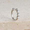 Macro detail of silver C-shaped ear cuff with three white pearls on stone background - Pearl Open Style (E1683 Silver)