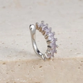 Makro-Detail des silbernen Ohrclips mit fünf lila Zirkonia auf einer beigen Steinfläche - Lila Quadratischer Stein Stil (E1690 Silber)
