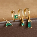 Detailed macro view of gold-plated earring set featuring marquise-cut green zircon stones - Gold
