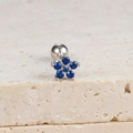 Detail shot of a silver flower ear stud with blue zircon petals on a textured stone base - Flower Stud (E1078) / Silver-Dark Blue