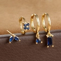 Detailed macro view of four-piece gold earring set with deep blue marquise-cut zircons - Gold Dark Blue Geometric Floral Style (E1410) / Gold