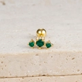 Macro shot of gold ear stud with three green zircons and screw-back ball closure - Gold-Green