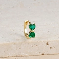 Detailed close-up of a gold bow earring with two heart-shaped green cubic zirconia stones - Gold-Green