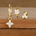 Macro shot of gold-plated floral earrings set with zircon details on wood stand - Four-petaled Flower Pendant Style (E1610-1) / Gold
