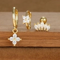 Macro view of S925 sterling silver gold clover earrings with micro-set zircons on wood - Gold