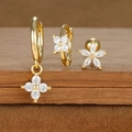 Detailed macro view of gold plated earrings set with cubic zirconia and S925 hallmark - Star and Flower Combo Style (E1610-12) / Gold
