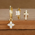 Detailed view of gold-plated star and moon earrings set with sparkling zircon inlays - Petal and Cross Style (E1610-13) / Gold