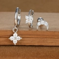 Detail of S925 silver earrings set with zircon stars and moon on a wooden stand - Silver