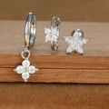 Detailed close-up of silver-tone star and floral earrings set with cubic zirconia stones - Micro-pave Flower and Star Style (E1610-9) / Silver