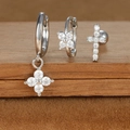 Detailed macro shot of silver zircon star and moon earring set on a wooden display - Four-petaled Flower and Cross Style (E1610-13) / Silver