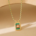 Détail d'un pendentif Tarot Mauvais Œil avec cordon tressé coloré et oxydes de zirconium - Mauvais Œil Vert