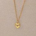 Golden heart locket necklace with sunburst engraving and a central blue birthstone - June