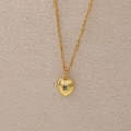 Golden heart locket necklace with blue birthstone and starburst engraving detailing - September