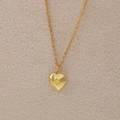 Vintage golden heart locket necklace featuring a central yellow sunstone on a fine chain - November