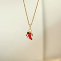 Detailed close-up of gold necklace with red high heel, lipstick and perfume bottle charms - Red High Heels Necklace