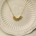 Golden MAMA necklace with a yellow teardrop gemstone pendant on a refined cross chain - November