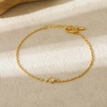 Detail view of gold birthstone bracelet with round champagne and clear crystals - November-B Style