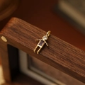 Robot style pendant with gold frame and purple gemstone on a walnut box - June Boy